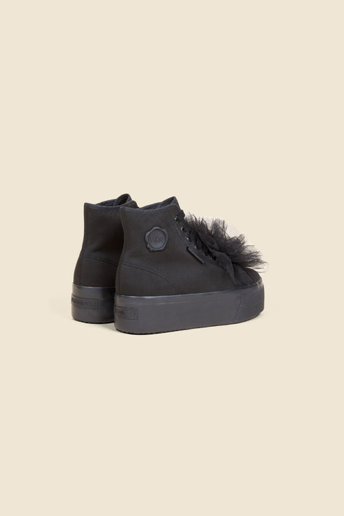 Black high-top sneakers with tulle detailing and platform sole, featuring a subtle logo patch on the side.