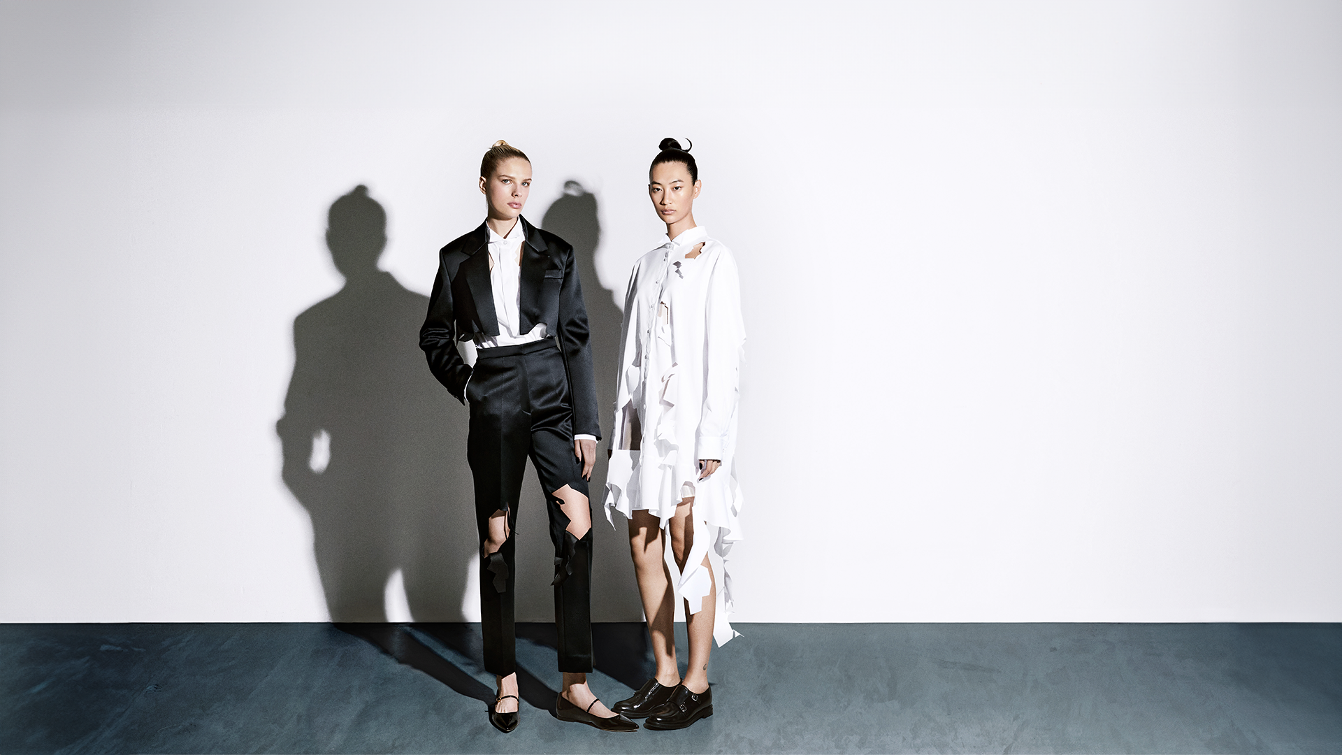 2 Viktor&Rolf models showcasing designer clothing