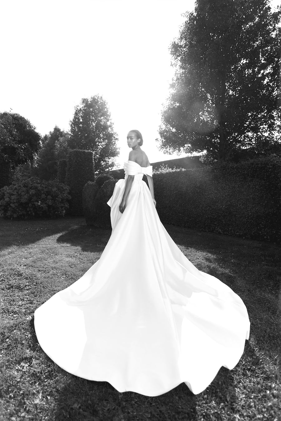 Viktor & Rolf Mariage Bridalwear Collection, Pick-up bow gown, elegant off-shoulder design with flowing train.