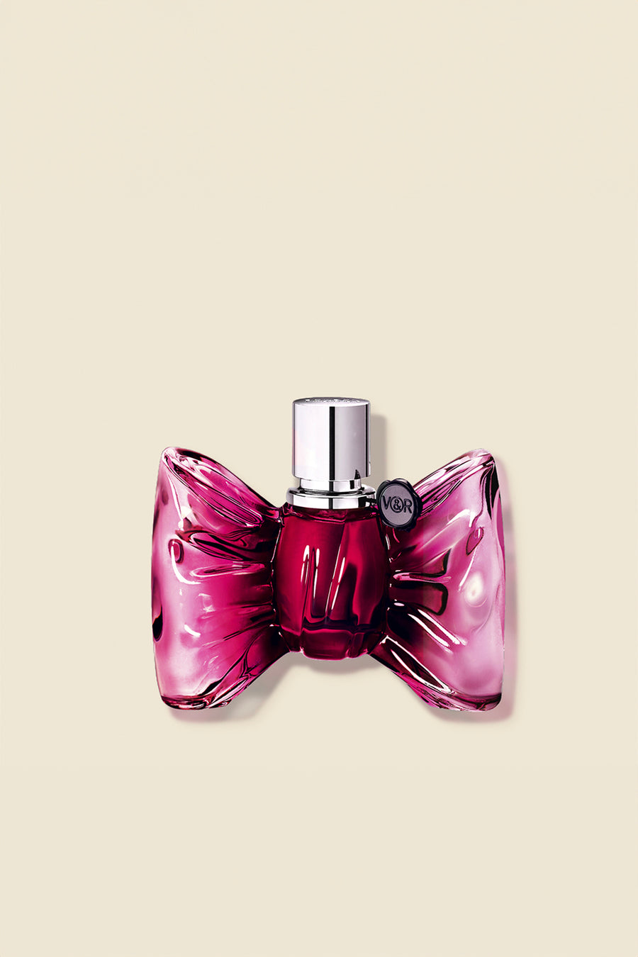 Pink Bonbon Eau de Parfum bottle for women, shaped like a bow with a glossy finish, exuding a sweet and elegant fragrance.