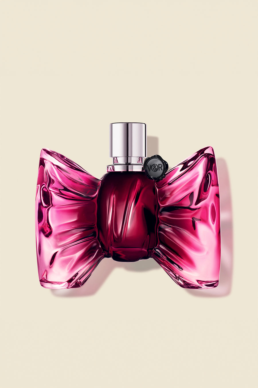 A luxurious bottle of Bonbon Eau de Parfum for women, shaped like a vibrant pink bow, exuding elegance and femininity.