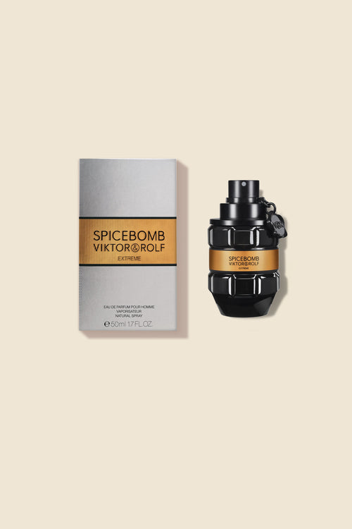 Viktor & Rolf Spicebomb Extreme fragrance bottle and box, featuring a sleek black grenade design with gold accents.