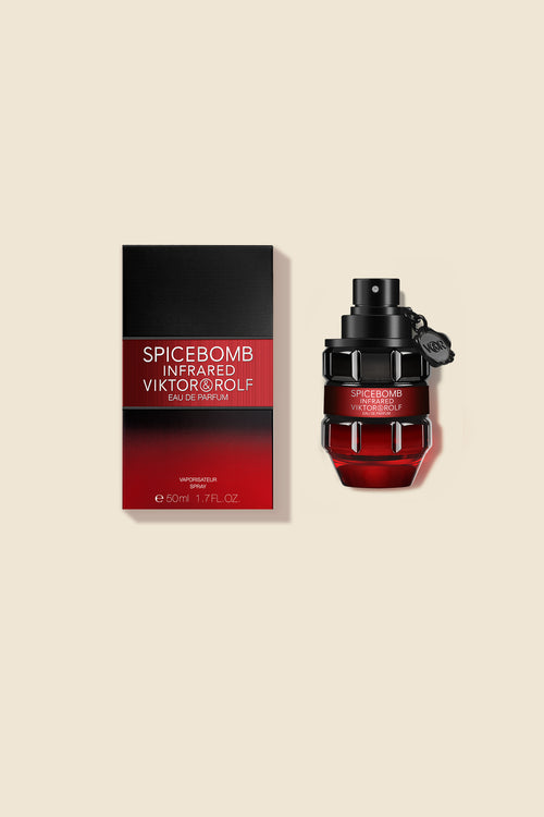 A sophisticated red and black perfume bottle with a matching box featuring a bold, modern design.