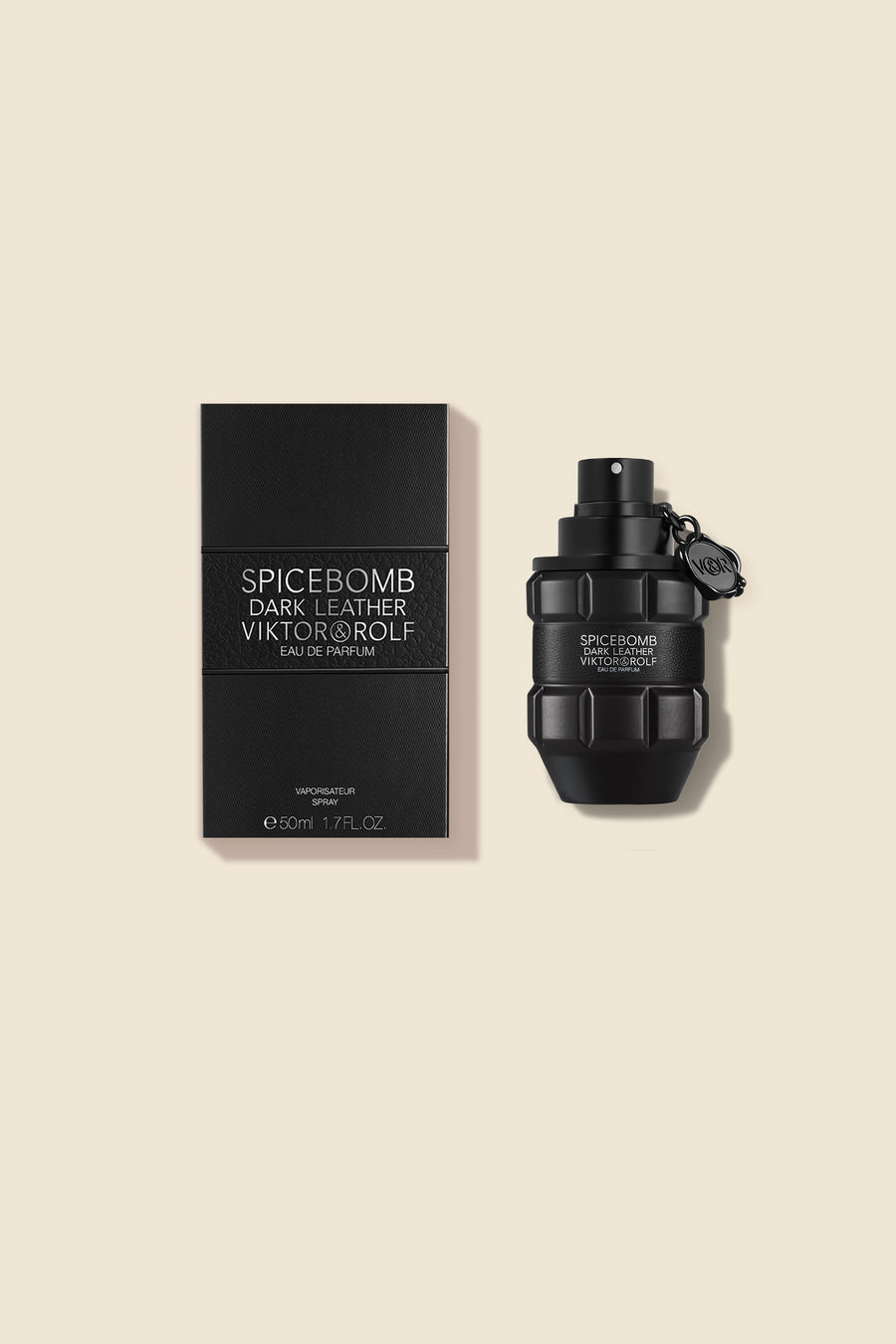 Elegant grenade-shaped bottle of Viktor & Rolf's Dark Leather Eau de Parfum beside sleek black packaging.