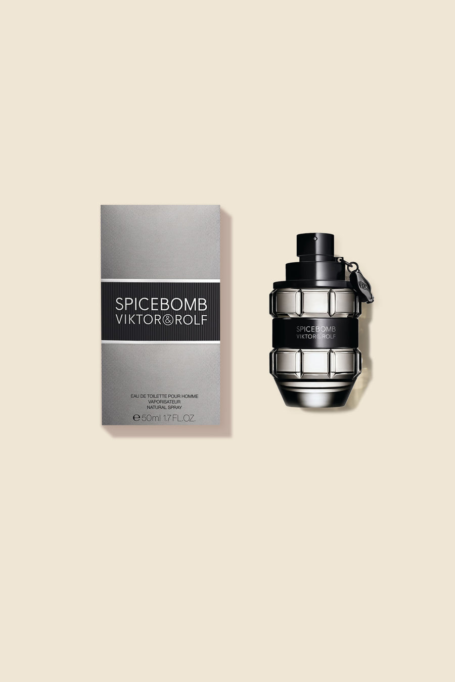 Men’s fragrance bottle with grenade design alongside gray box, showcasing sleek black and metallic accents.