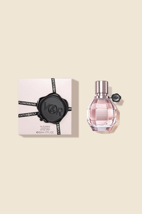 Elegant Flowerbomb Eau de Parfum by Viktor & Rolf, featuring a faceted bottle and delicate pink hue for women.