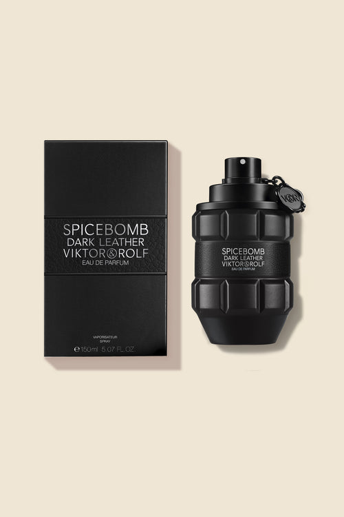 Elegant black grenade-shaped bottle of men's perfume with matching box, labeled "Spicebomb Dark Leather Eau de Parfum."