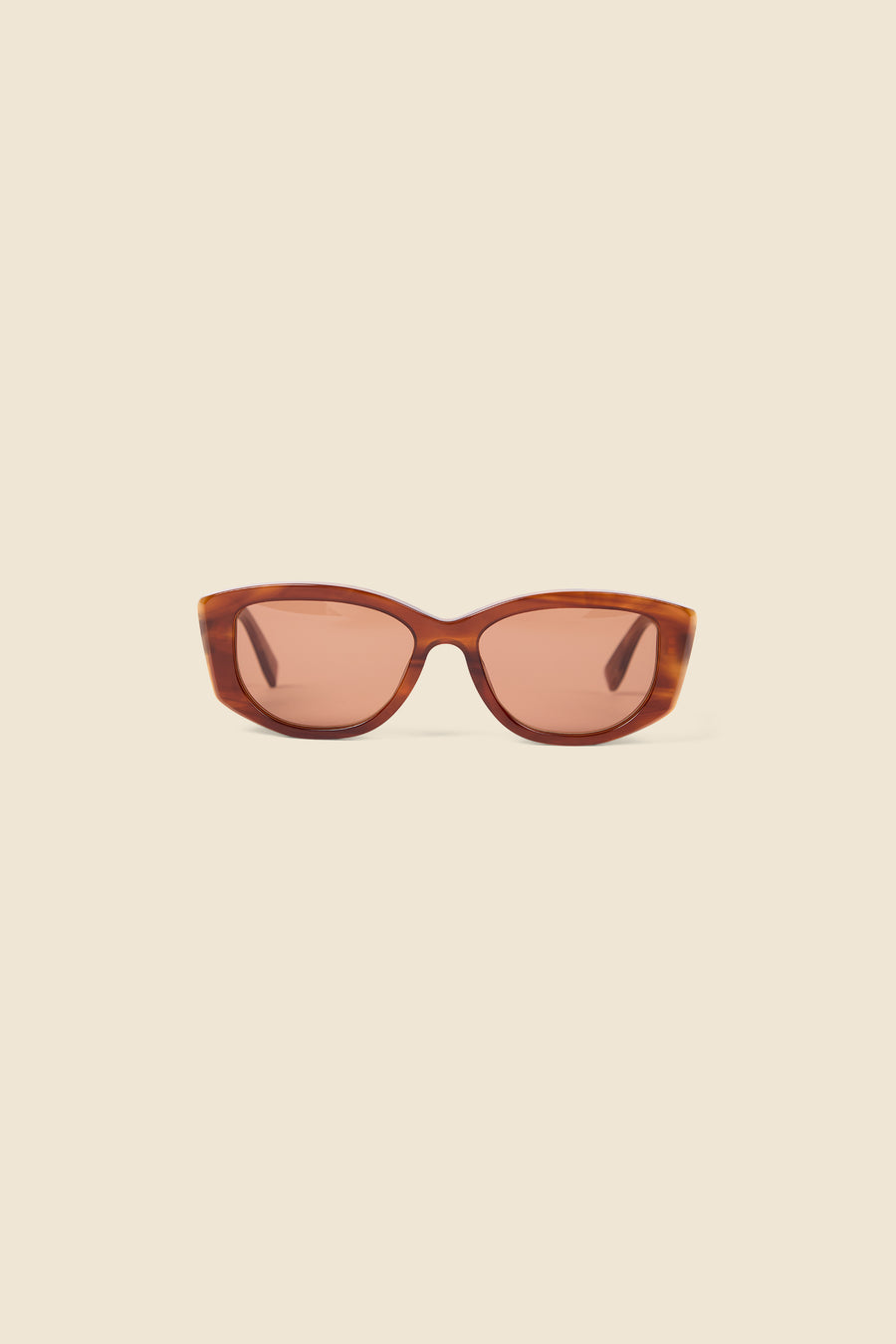 Stylish cat-eye sunglasses with tortoiseshell frame and warm brown lenses, set against a neutral backdrop.