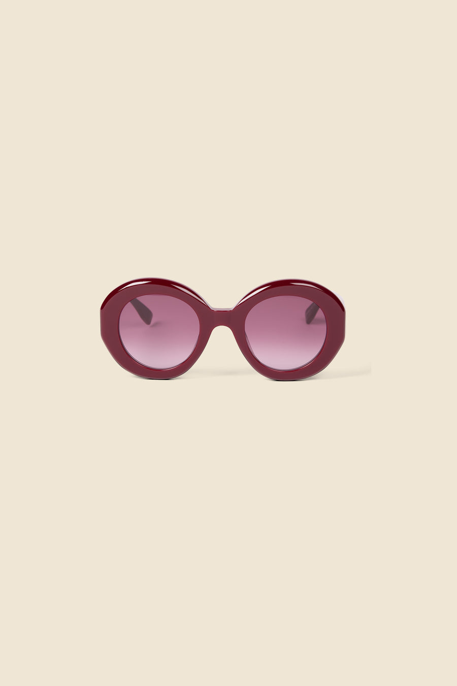 Round sunglasses with glossy burgundy frames and gradient plum lenses, set against a neutral background.