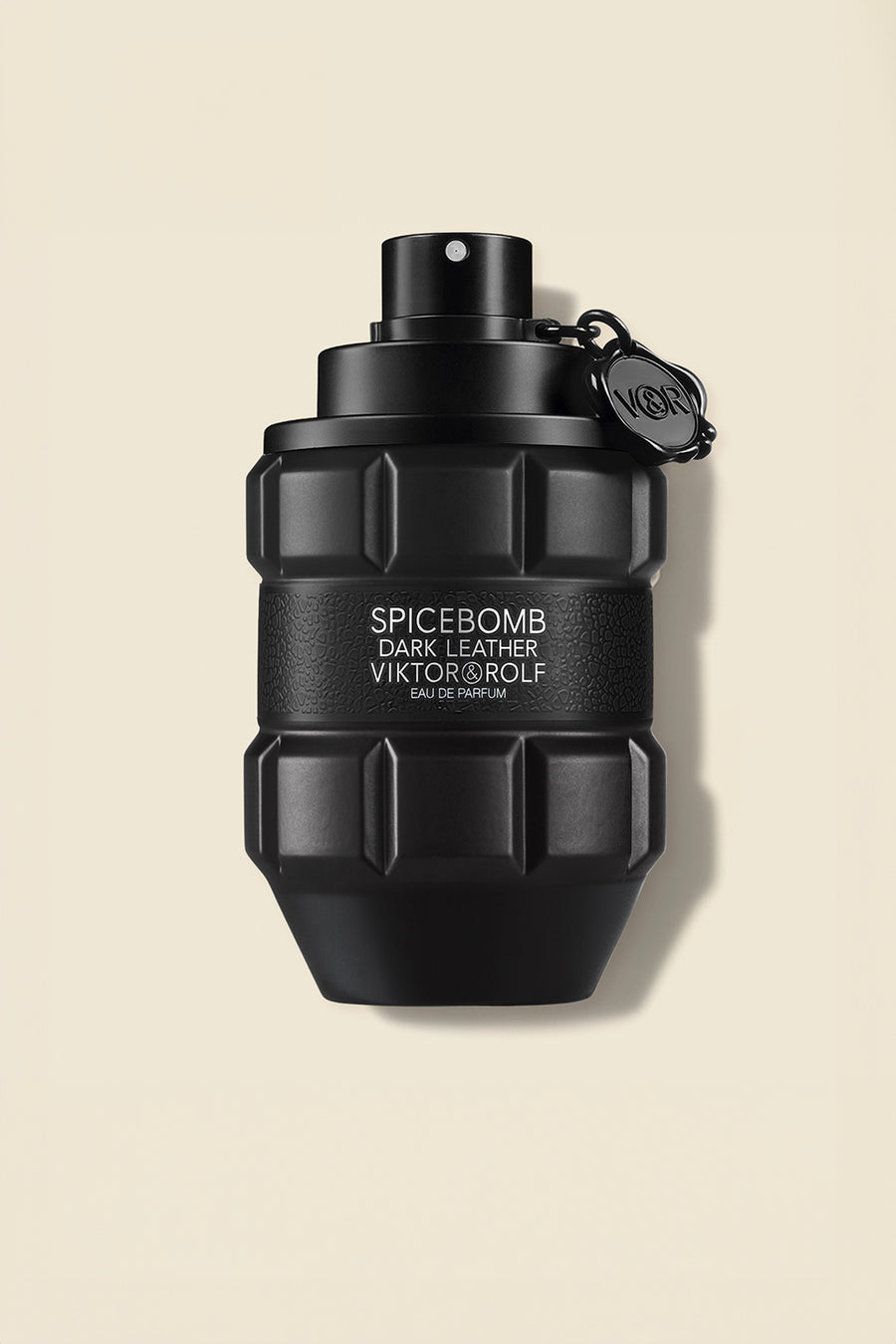 Black grenade-shaped perfume bottle with embossed logo detailing, designed with a sleek matte finish for a bold, edgy appeal.