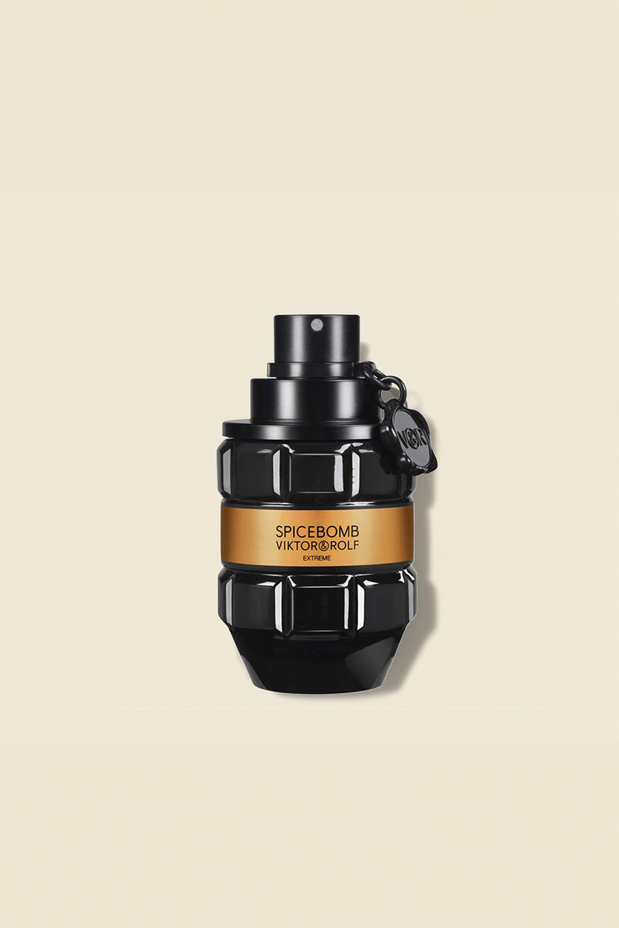 Black grenade-shaped perfume bottle with an amber label, featuring sculpted geometric facets, against a cream background.