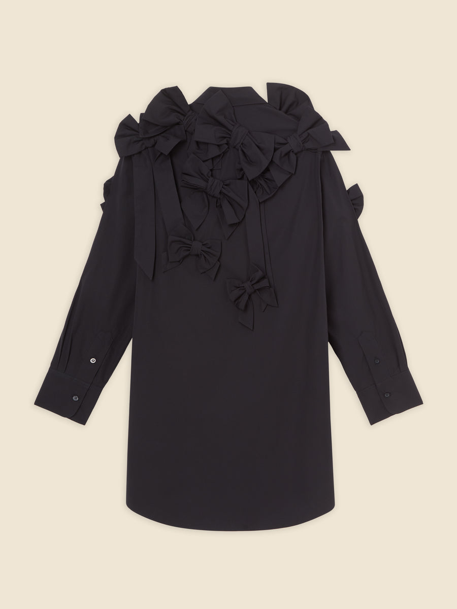 Elegant black blouse adorned with intricate bow embellishments on the shoulders, creating a sophisticated and unique design.