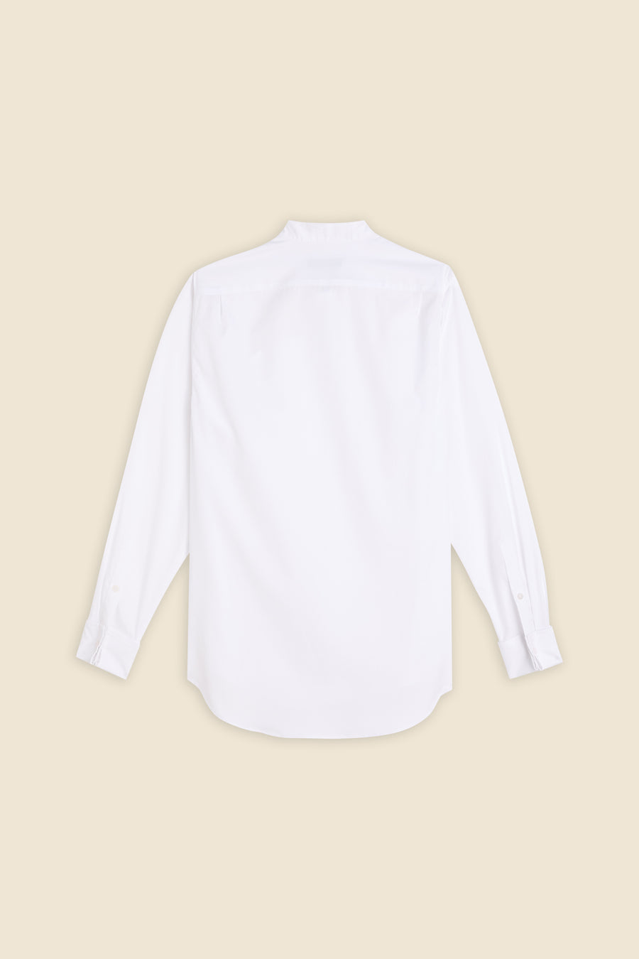 Back view of a classic white cotton long-sleeve dress shirt with buttoned cuffs on a beige background.