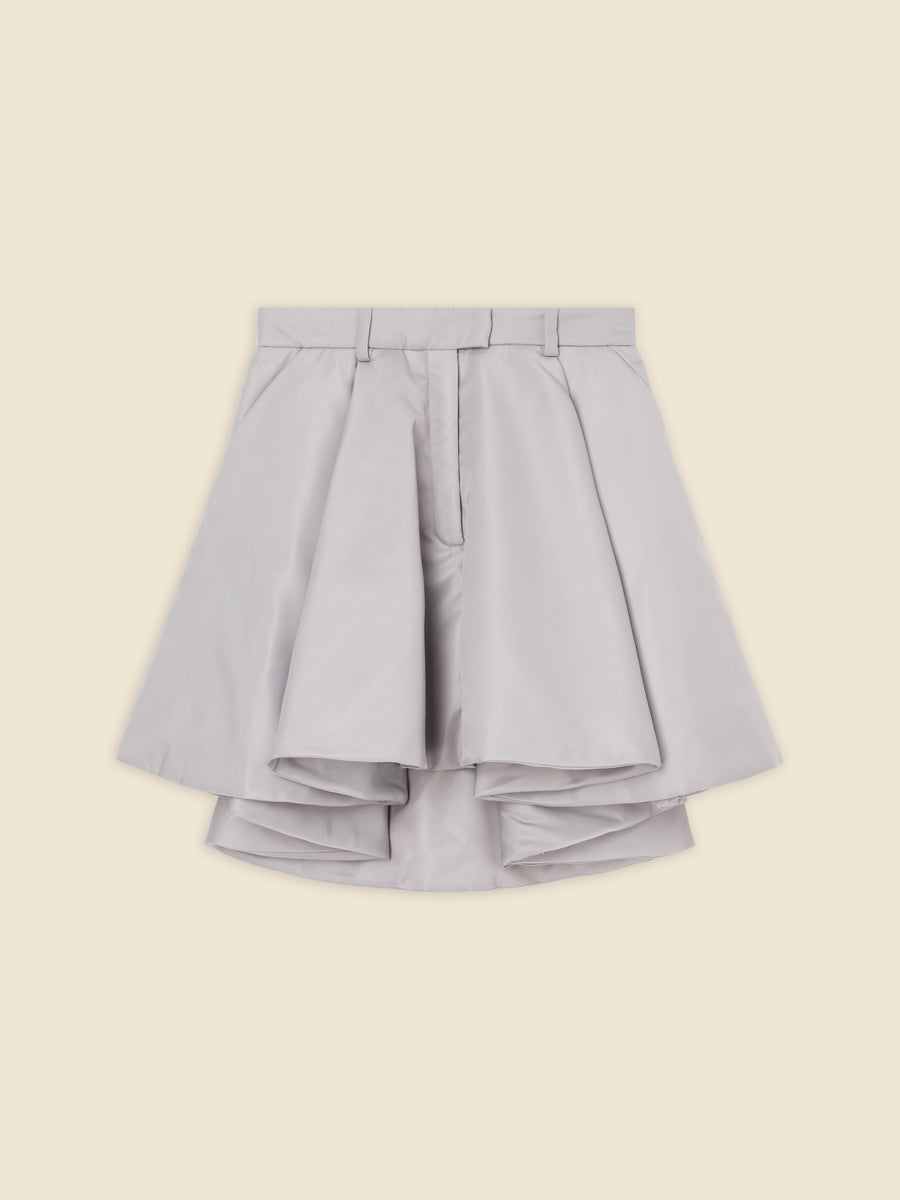 Silver satin mini skirt with layered pleats and a structured A-line silhouette, creating a chic and modern look.