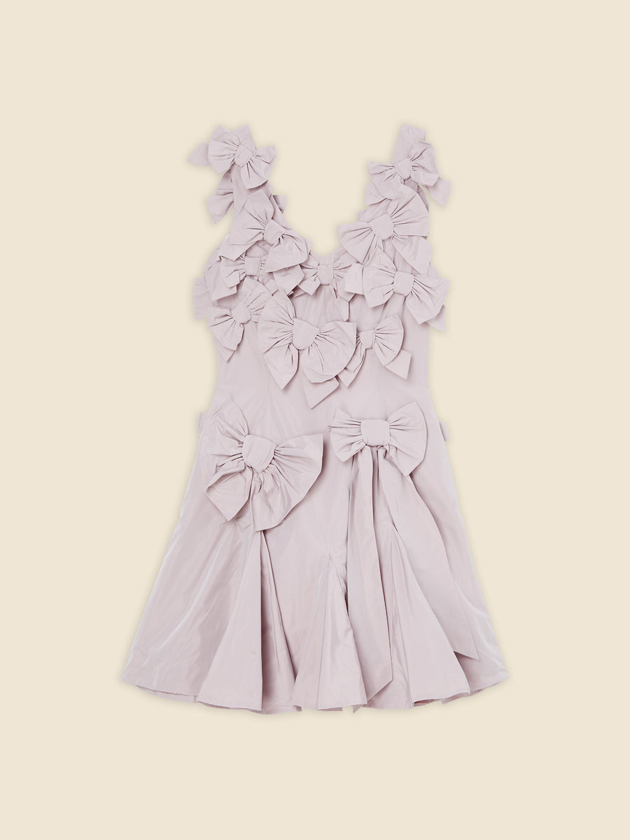 Elegant dress with multiple large bows in soft lavender color, featuring a sleeveless design and pleated skirt detailing.