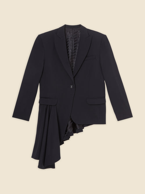 Elegant black blazer with asymmetrical ruffle detail, featuring a classic lapel and sleek tailored fit on beige background.