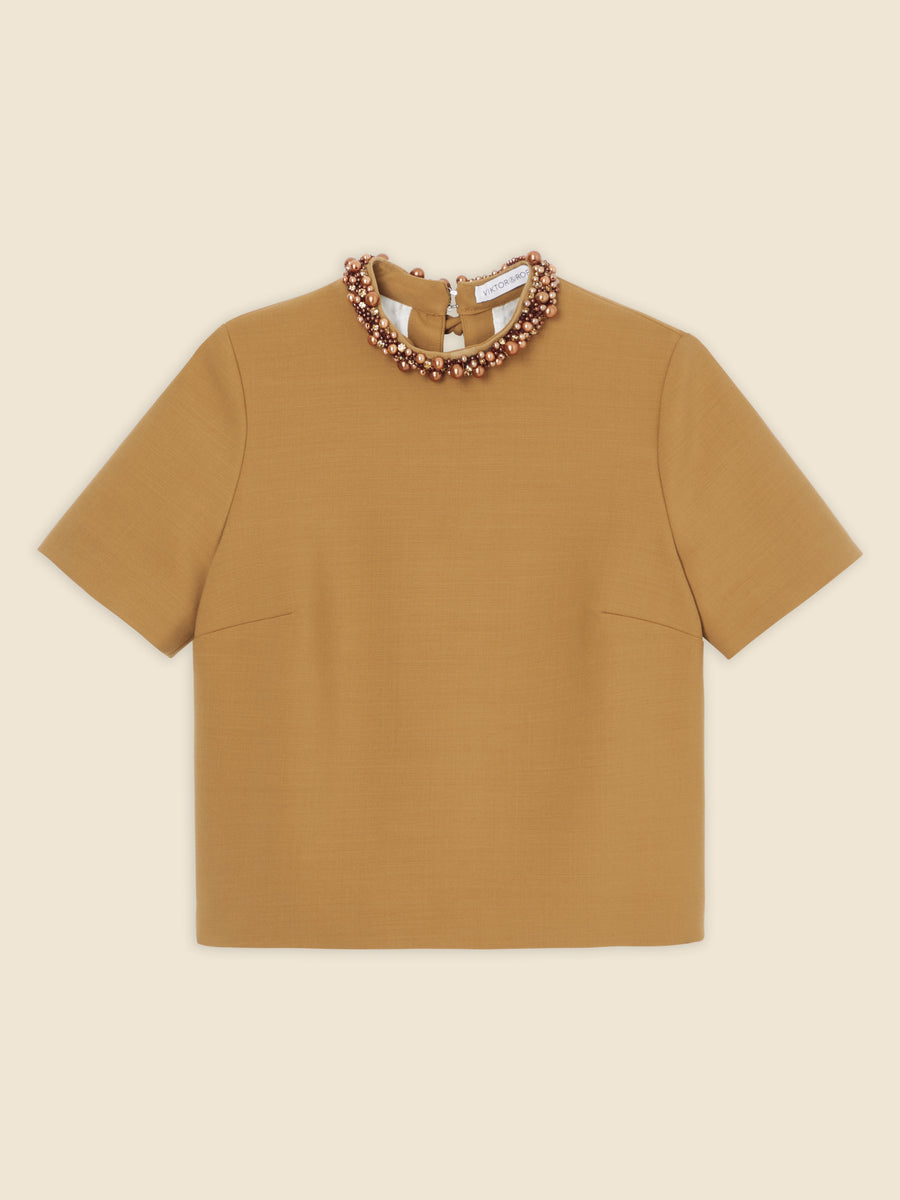 Short-sleeve mustard-colored blouse with decorative beaded collar detail, designed for stylish and elegant wear.