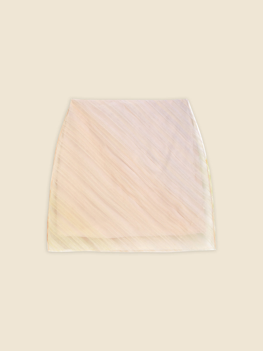 Elegant beige organza mini skirt with diagonal pleats, featuring a subtle translucent texture on a neutral background.