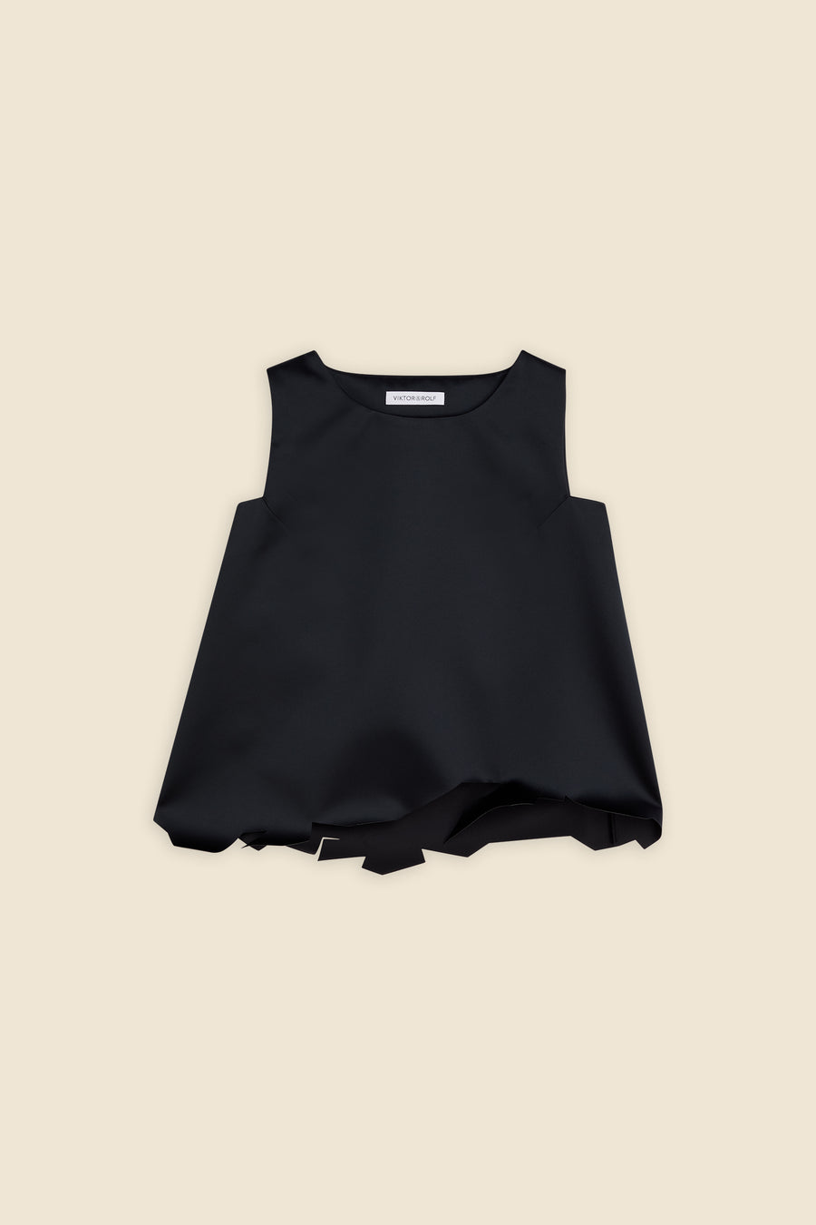 Elegant black sleeveless top with unique asymmetrical hemline on a neutral beige background.